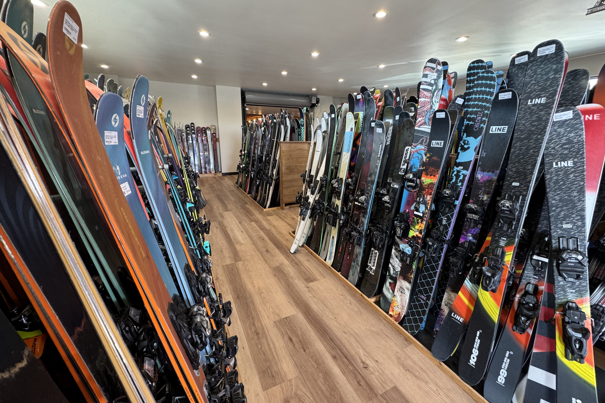 Used skis on a tuning bench being inspected